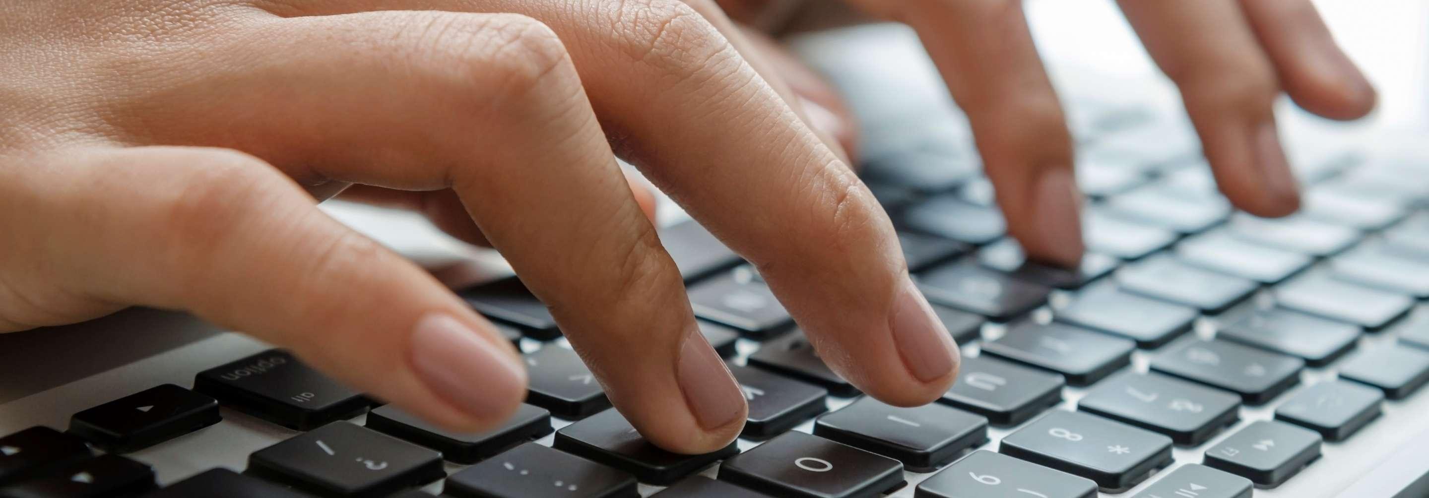 Close up of a data entry representative typing on a keyboard