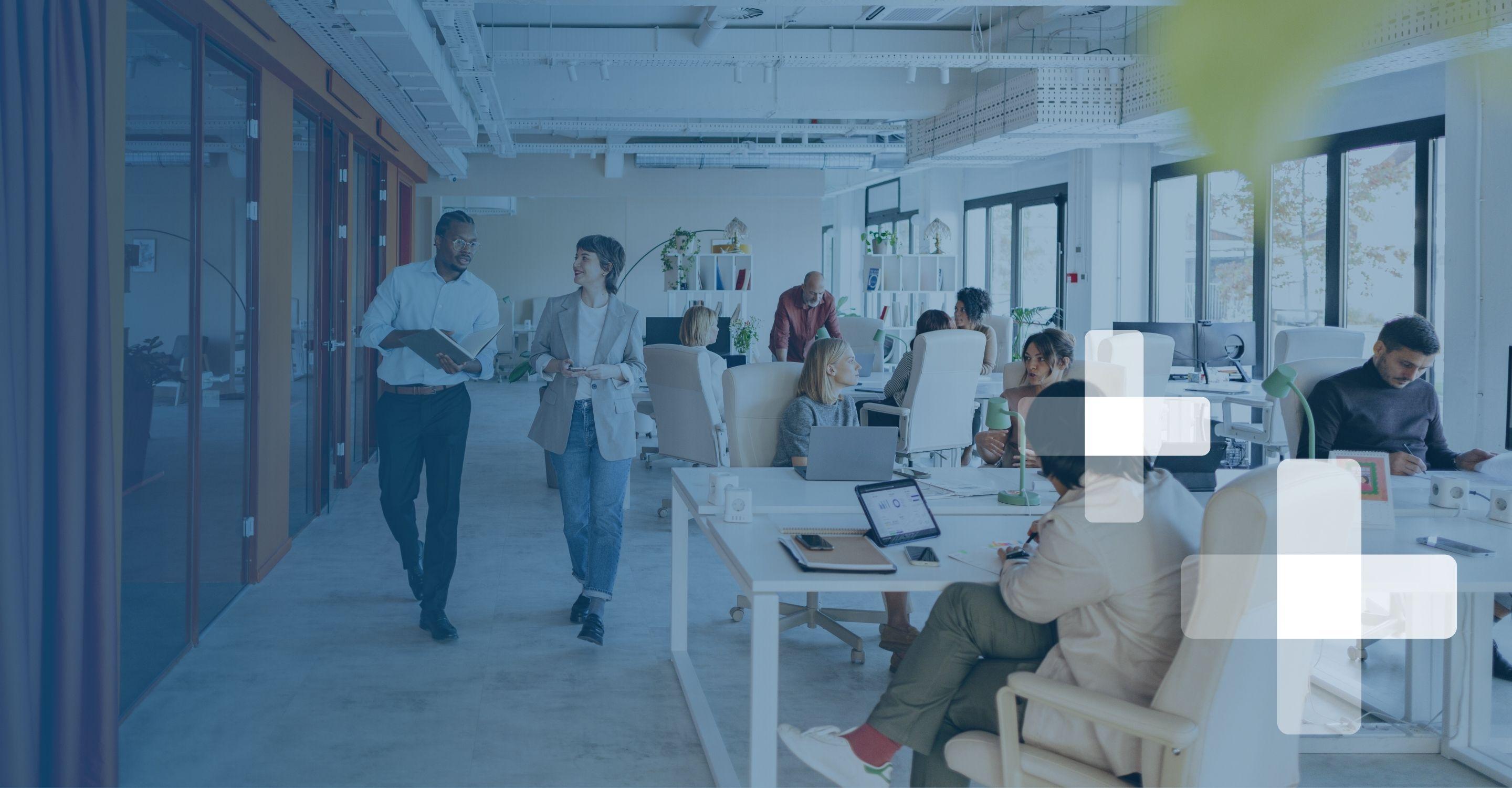 A brightly lit modern office where employees work at open workstations