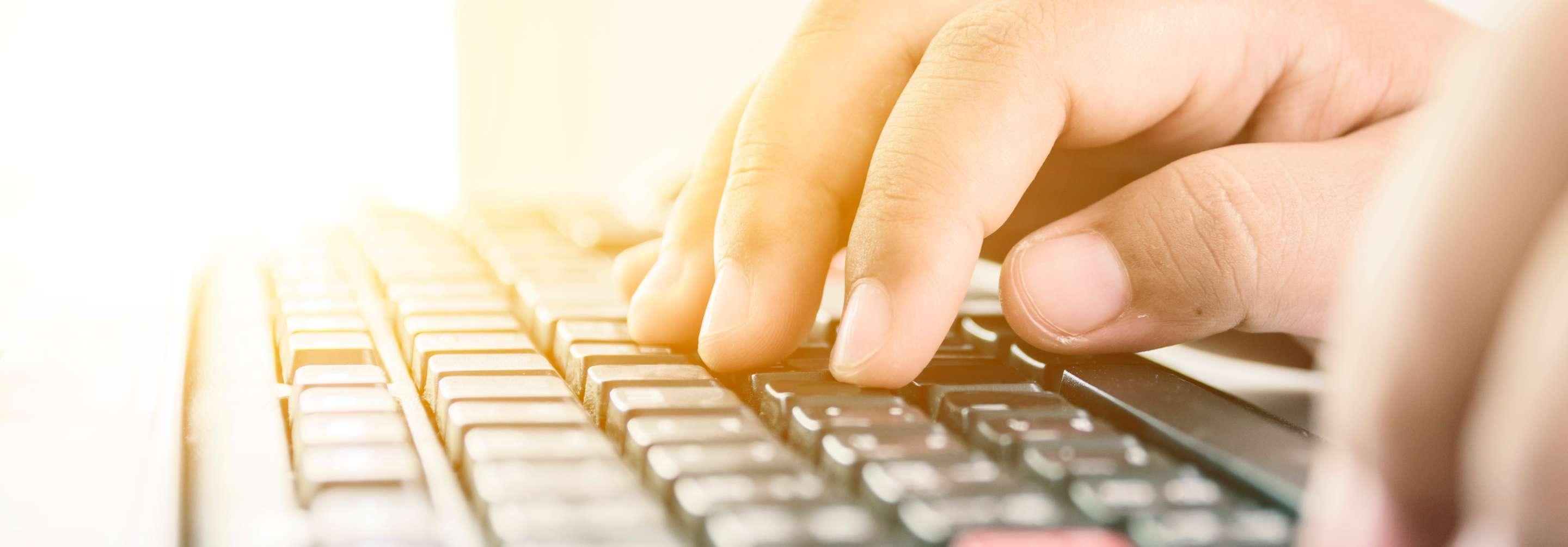 Close up of a data entry specialist typing on a keyboard
